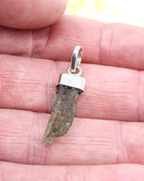 Natural Czech Moldavite pendant in sterling silver featuring a raw elongated green Moldavite crystal with authentic texture and transformational energy.