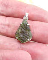 Genuine Czech Moldavite pendant in .925 sterling silver claw setting featuring natural green Moldavite from the Czech Republic.