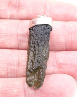 Genuine Czech Moldavite pendant in .925 sterling silver featuring a natural elongated Moldavite crystal from the Czech Republic with rich green colouring and natural texture.