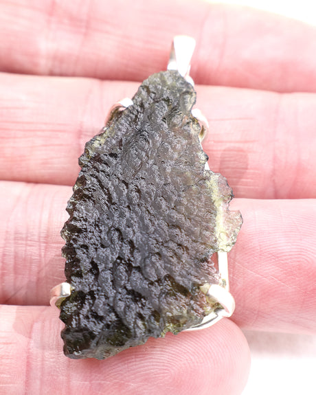 Genuine Czech Moldavite pendant in .925 sterling silver featuring a large natural Moldavite specimen with detailed etched texture, translucent green colouring and cosmic transformational energy from the Czech Republic.