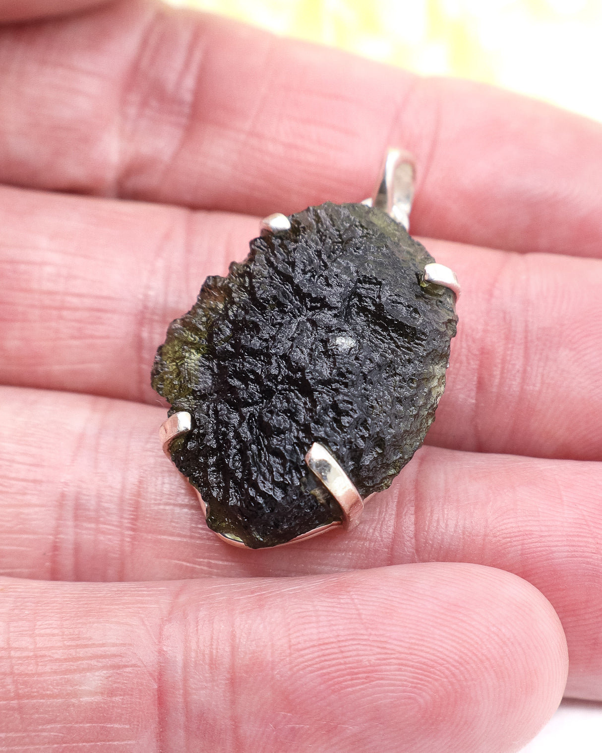 Genuine Czech Moldavite pendant in .925 sterling silver featuring deeply etched natural texture, translucent green colouring and powerful transformational energy from the Czech Republic.