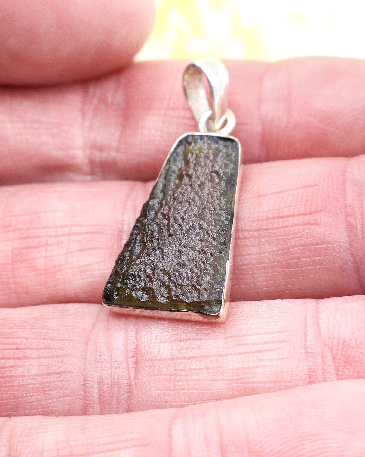 Genuine Czech Moldavite pendant in .925 sterling silver featuring natural etched texture, olive-green colouring and powerful transformational energy.