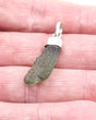 Natural Czech Moldavite pendant in sterling silver featuring an elongated raw green tektite with beautiful texture and powerful transformational energy.