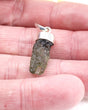 Natural Czech Moldavite pendant in sterling silver featuring an elongated raw green Moldavite crystal with beautiful texture and powerful transformational energy.