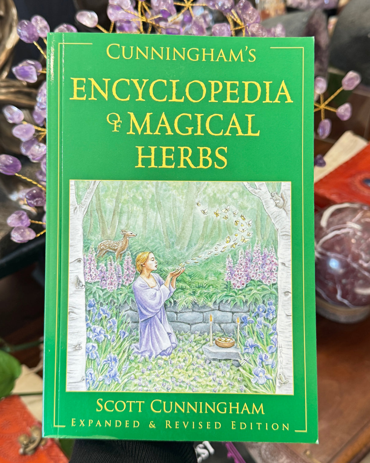 Cunningham’s Encyclopedia of Magical Herbs by Scott Cunningham featuring green cover artwork and expanded revised edition subtitle.