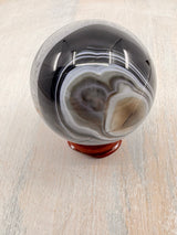 Banded Black Agate Sphere 279g - "I release all behaviours that no longer serve me."