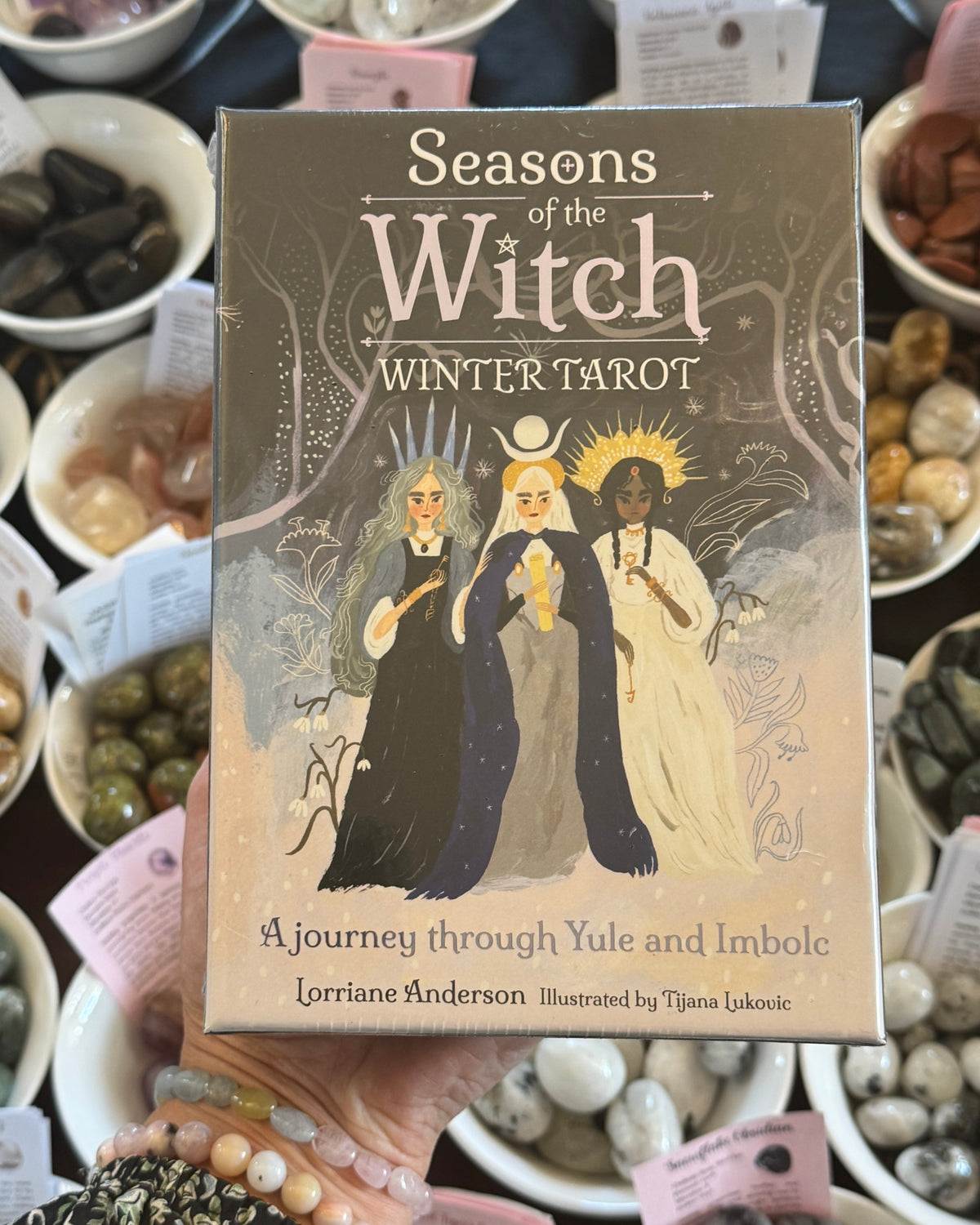 Seasons of the Witch Winter Tarot 78 card deck by Lorraine Anderson, illustrated by Tijana Lukovic, magical Yule and Imbolc witchcraft tarot cards with winter goddesses and mystical seasonal artwork.