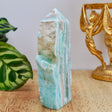 10.5cm Hemimorphite freeform point weighing 186g with aqua-blue and white banding and natural cavity detail.