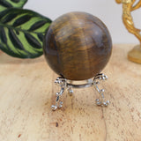 Tiger Eye sphere 349g with golden chatoyancy on decorative stand
