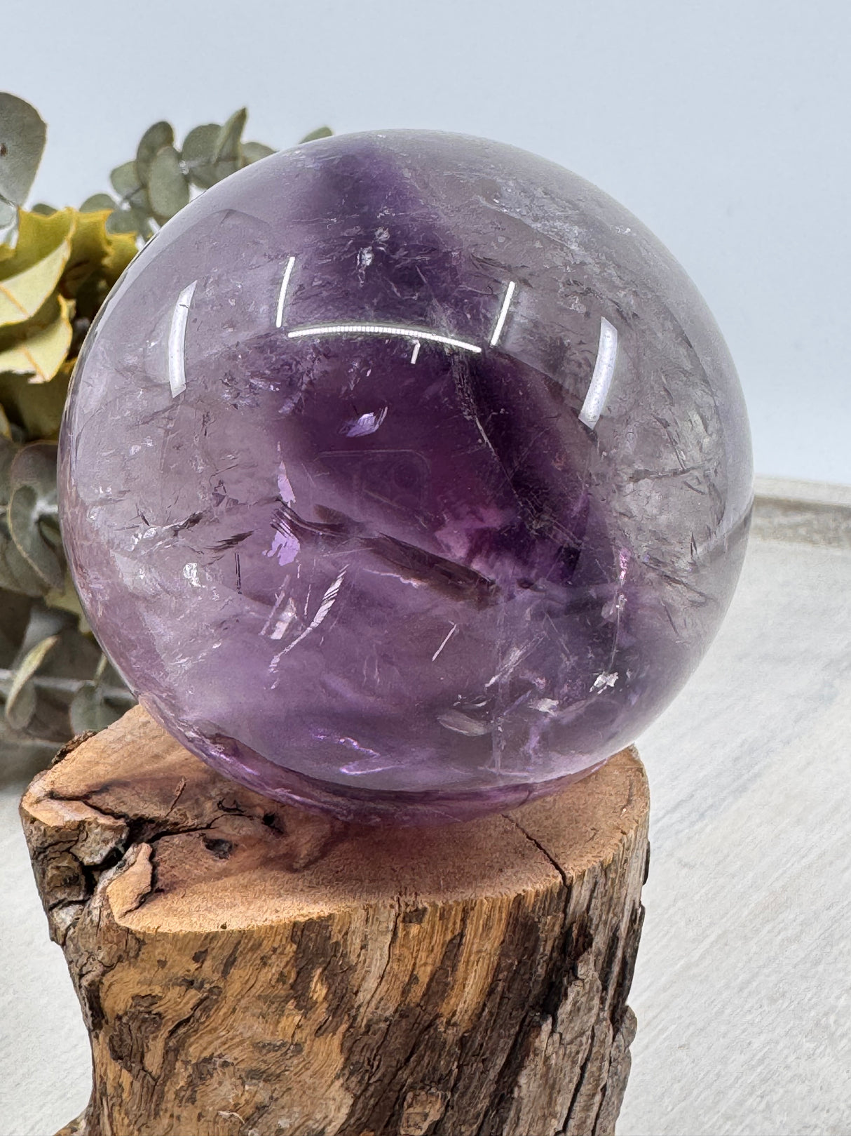 Amethyst Sphere – polished purple crystal sphere symbolising peace, intuition and healing, Inspired By 3 Australia. under lights