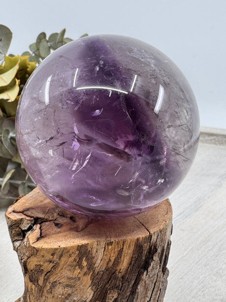 Amethyst Sphere – polished purple crystal sphere symbolising peace, intuition and healing, Inspired By 3 Australia. under lights
