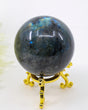 Genuine Labradorite Crystal Sphere 284g featuring vibrant blue labradorescence flashes displayed on a decorative gold stand.