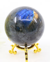 Genuine 303g Labradorite Crystal Sphere with brilliant blue and gold flash displayed on a decorative gold stand.