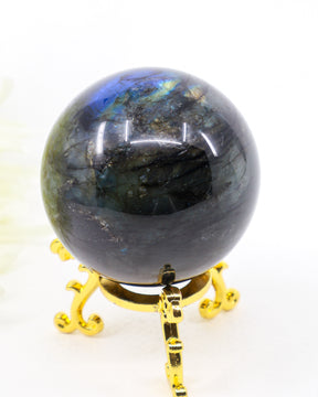 253g Genuine Madagascan Labradorite Crystal Sphere with brilliant blue, aqua and golden flash displayed on a decorative gold stand.