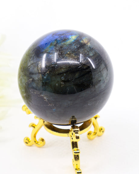 253g Genuine Madagascan Labradorite Crystal Sphere with brilliant blue, aqua and golden flash displayed on a decorative gold stand.