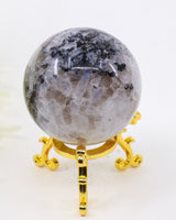 205g Rainbow Moonstone Sphere with natural blue flash, silvery white feldspar crystals and black inclusions, polished into a premium crystal sphere.
