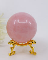 Natural Rose Quartz Crystal Sphere weighing 257g with soft pink colouring, polished finish and gold display stand for emotional healing, love and Heart Chakra meditation.