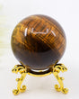 195g Tiger Eye Gold Sphere with rich golden chatoyancy displaying natural bands of golden brown and deep chocolate tones on a polished crystal sphere.