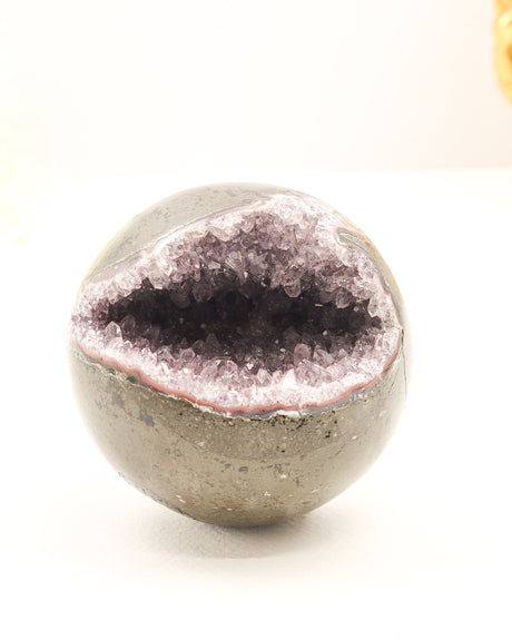 Natural Amethyst Cluster Sphere 614g with sparkling crystal cave opening, druzy crystals and polished outer shell displaying soft purple Amethyst formations.