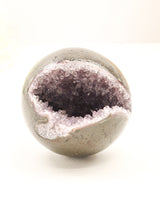 Natural Amethyst Cluster Sphere 614g with sparkling crystal cave opening, druzy crystals and polished outer shell displaying soft purple Amethyst formations.