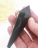 Black Agate crystal wand 75g 10cm with natural black and smoky grey banding, polished protection and grounding crystal point.