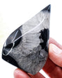 Black Banded Agate Flame 131g with glossy jet-black Agate and icy grey crystalline formations, polished 8.5cm protection and grounding crystal.