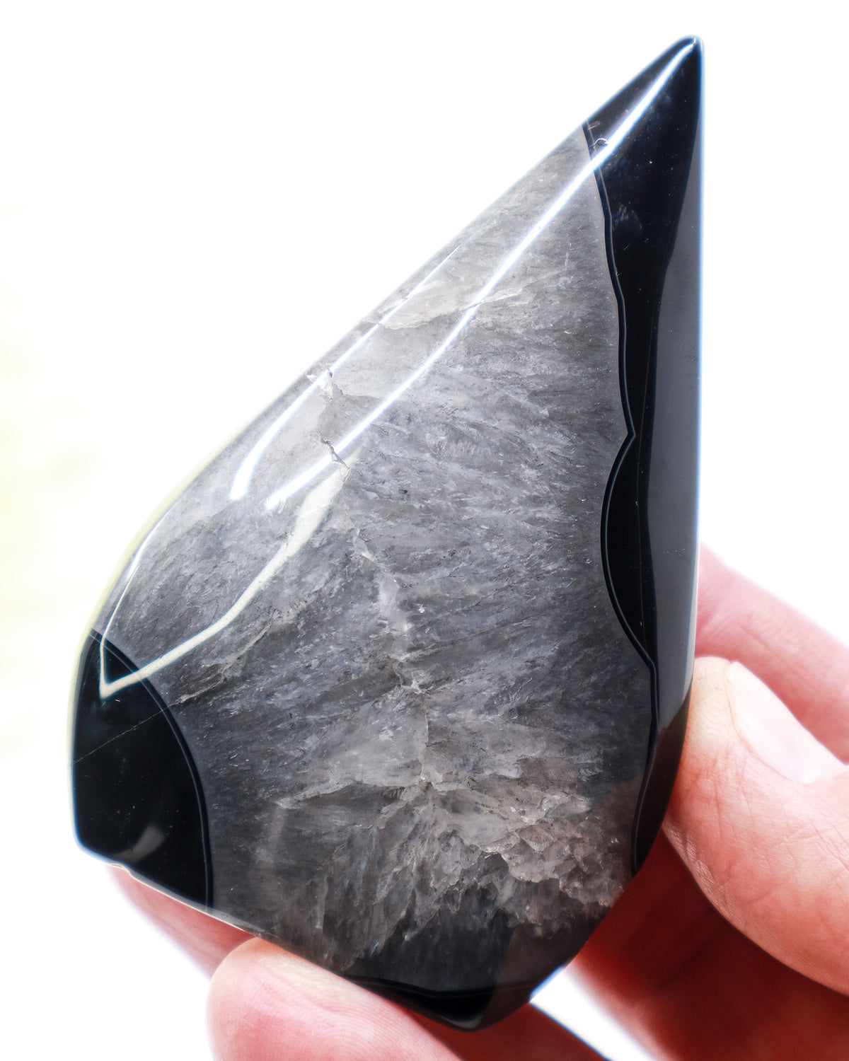 Black Banded Agate Flame 141g with glossy black bands and smoky grey crystalline centre, polished 8.5cm protection and grounding crystal.