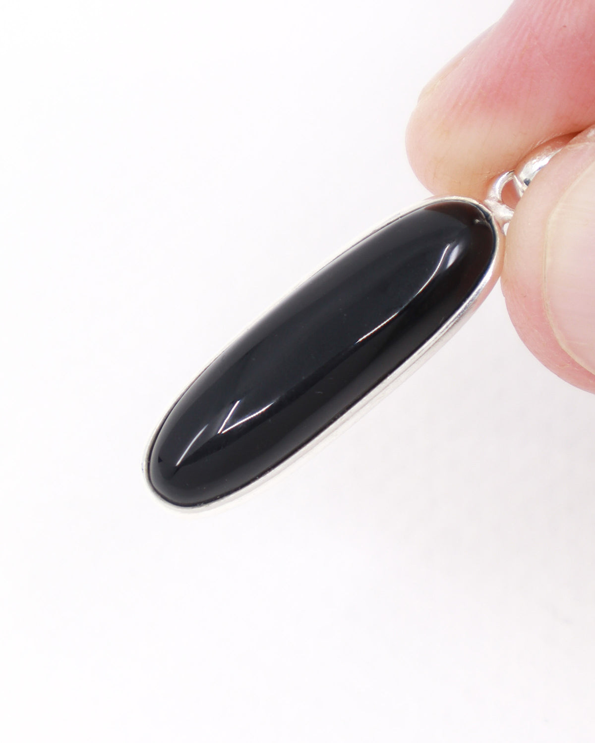 Black Onyx sterling silver pendant with elongated polished black gemstone set in .925 silver, grounding and protection crystal jewellery.