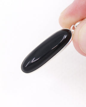 Black Onyx sterling silver pendant with elongated polished black gemstone set in .925 silver, grounding and protection crystal jewellery.