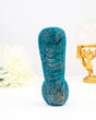 Hand carved blue apatite snake crystal carving with detailed scales and vibrant blue tones on white background