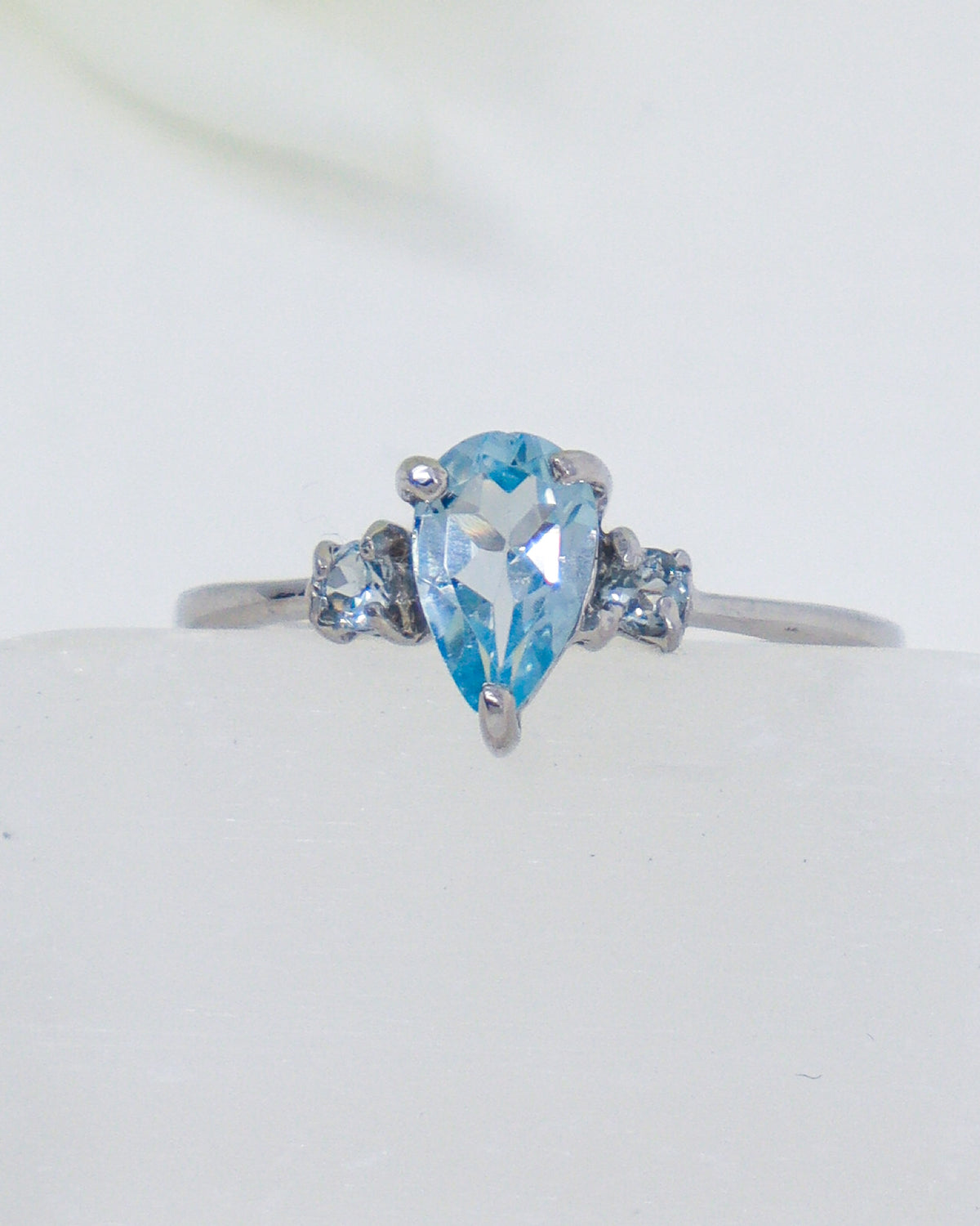 Blue Topaz sterling silver ring Size 8 with pear-cut blue gemstone and sparkling side stones in .925 silver.