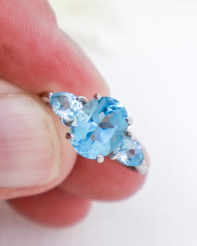Blue Topaz sterling silver ring Size 8 with oval Blue Topaz centre stone and pear-cut side stones in .925 silver.