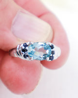 Blue Topaz and Black Spinel sterling silver ring size 7 with oval faceted natural Blue Topaz gemstone and black Spinel accent stones.
