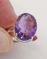 Brazilian Amethyst statement ring size 9 with large oval faceted purple gemstone set in .925 sterling silver.