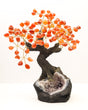 Carnelian gemstone bonsai tree with orange crystal leaves on a sparkling natural Amethyst geode base with twisted bonsai trunk.