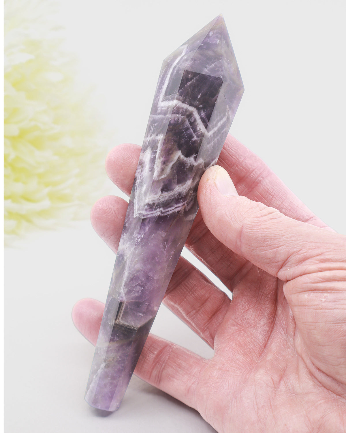 Natural Chevron Amethyst crystal wand 158g 16cm with purple and white quartz banding, polished point and gold display stand.