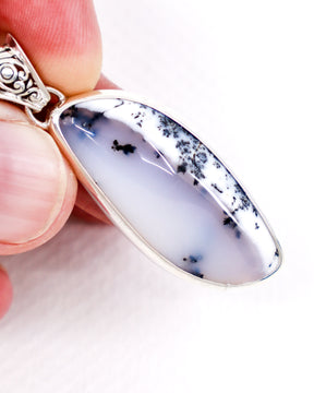Natural Dendritic Agate sterling silver pendant with translucent blue-grey Agate, white formations and black tree-like dendritic inclusions with ornate silver bail.