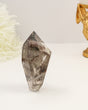 Polished Garden Quartz freeform point featuring smoky natural inclusions and scenic internal formations.
