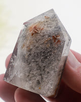 Phantom Garden Quartz crystal point 83g with smoky-grey mineral inclusions and natural internal formations.