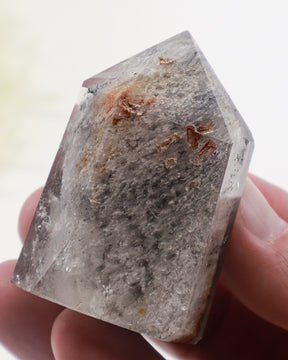 Phantom Garden Quartz crystal point 83g with smoky-grey mineral inclusions and natural internal formations.