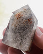 Phantom Garden Quartz crystal point 83g with smoky-grey mineral inclusions and natural internal formations.