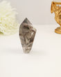 Polished Garden Quartz freeform point featuring smoky natural inclusions and scenic internal formations.