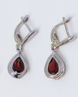 Natural Garnet sterling silver drop earrings with faceted pear shaped deep red Garnet gemstones in polished .925 silver settings.