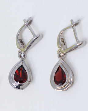 Natural Garnet sterling silver drop earrings with faceted pear shaped deep red Garnet gemstones in polished .925 silver settings.