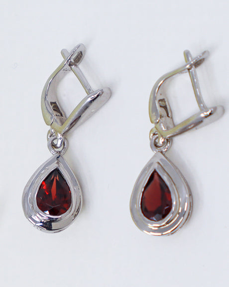Natural Garnet sterling silver drop earrings with faceted pear shaped deep red Garnet gemstones in polished .925 silver settings.