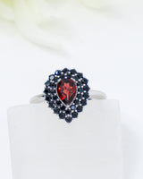Natural Garnet and Black Spinel sterling silver ring Size 7 with pear cut red Garnet surrounded by faceted Black Spinel gemstones.