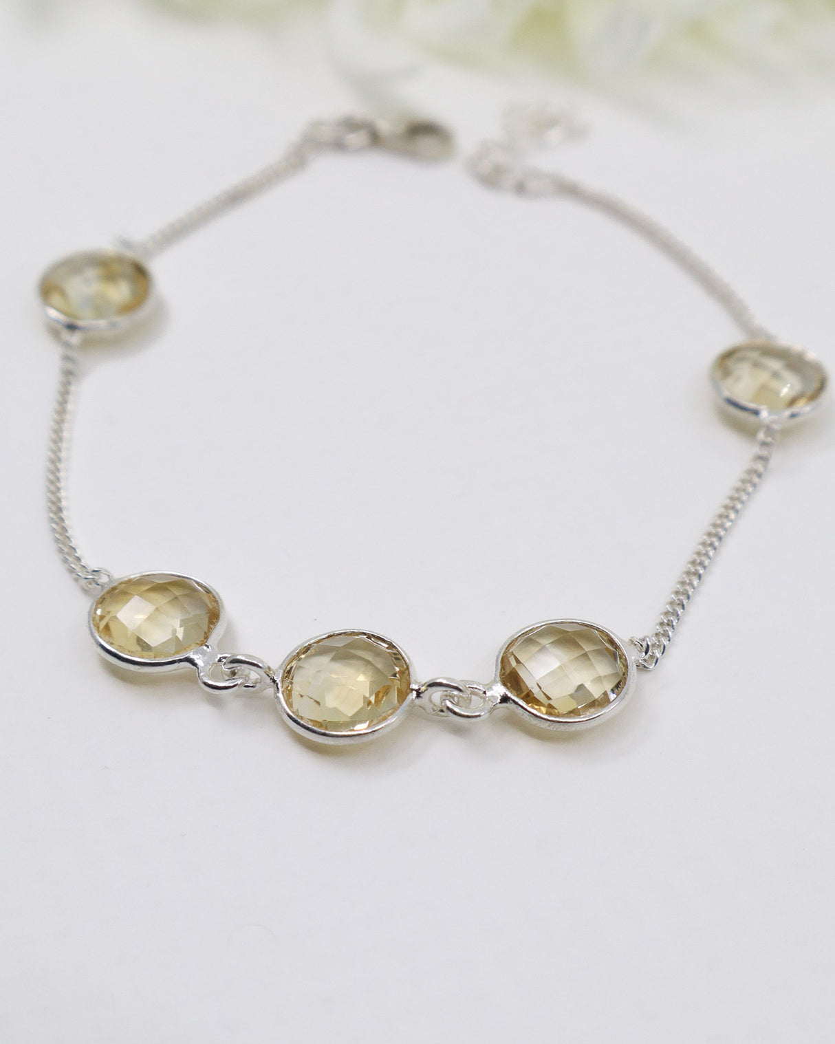 Faceted Citrine sterling silver bracelet with delicate chain and golden gemstone settings.
