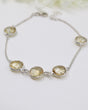 Faceted Citrine sterling silver bracelet with delicate chain and golden gemstone settings.