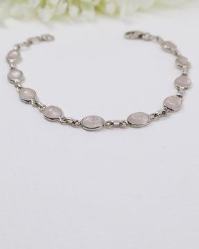 Delicate sterling silver Rose Quartz bracelet with soft pink gemstones displayed beside ruler for size reference.