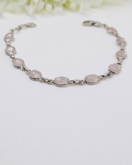 Delicate sterling silver Rose Quartz bracelet with soft pink gemstones displayed beside ruler for size reference.